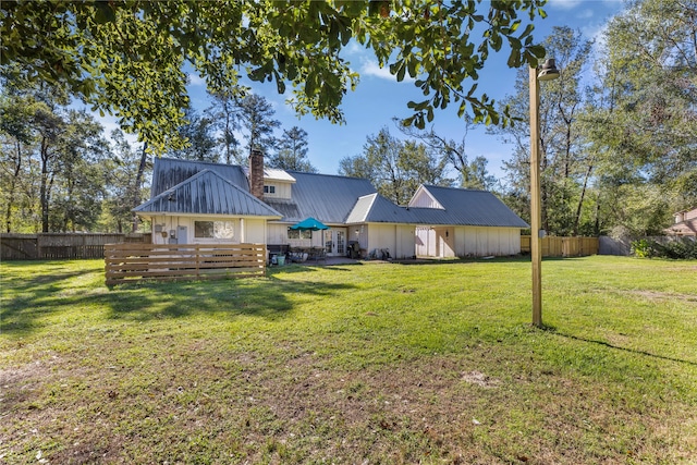 back of property featuring a lawn