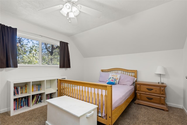 bedroom with a textured ceiling, ceiling fan, dark carpet, and vaulted ceiling