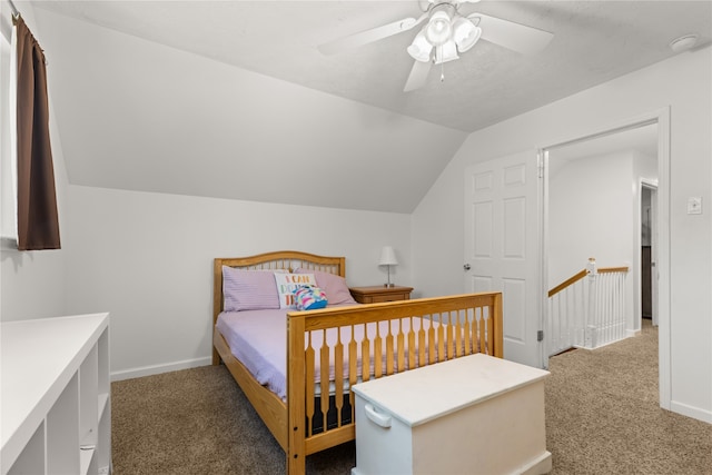 bedroom with dark colored carpet, ceiling fan, and lofted ceiling