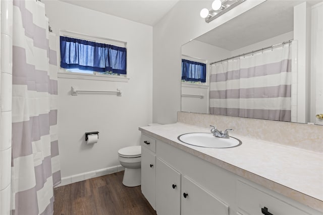 bathroom featuring hardwood / wood-style floors, vanity, and toilet