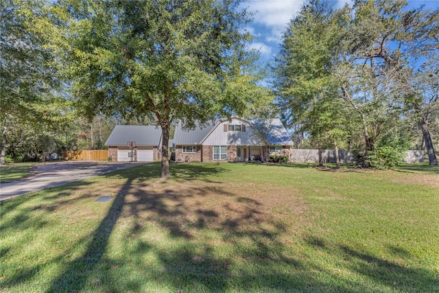 view of front of house with a garage and a front lawn