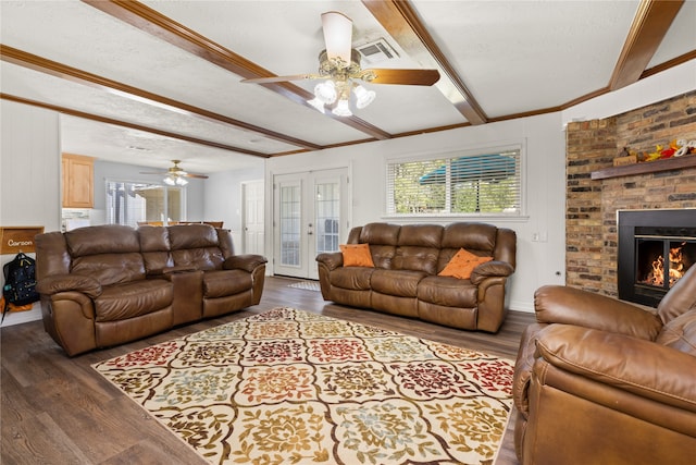 living room with a fireplace, a textured ceiling, dark hardwood / wood-style floors, and ceiling fan