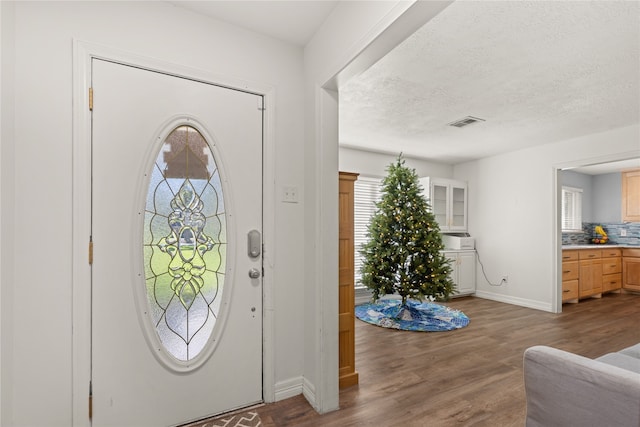 foyer with a textured ceiling and hardwood / wood-style flooring