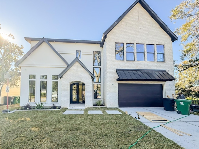 modern farmhouse featuring a front lawn and a garage