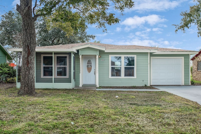 single story home featuring a front lawn and a garage