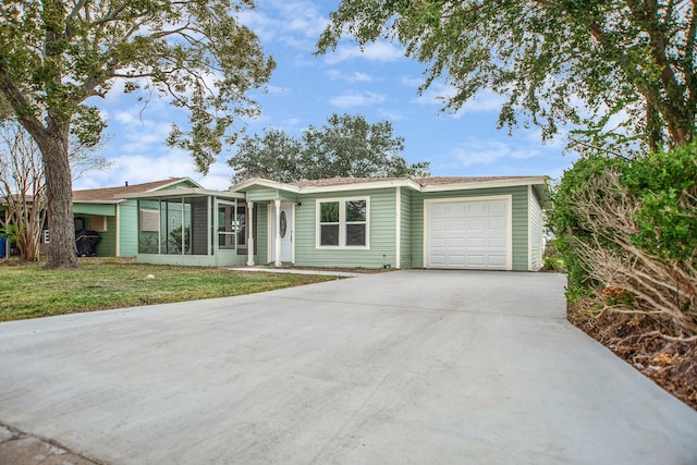 single story home featuring a garage and a front yard