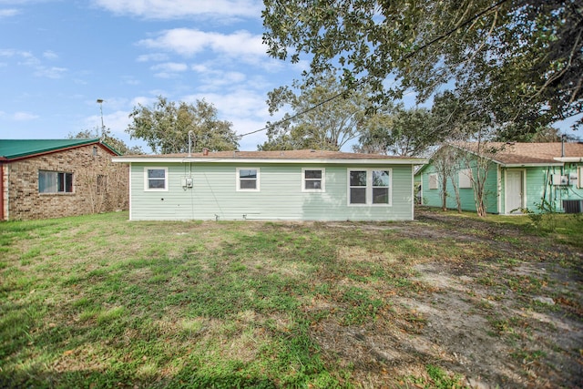 back of property featuring a yard