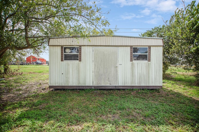 view of outbuilding with a lawn