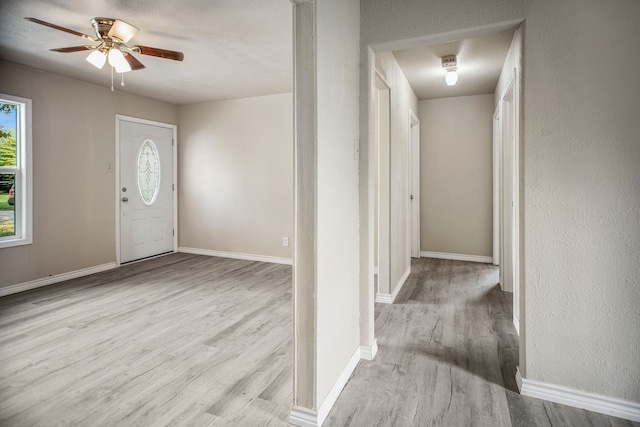 entryway with ceiling fan and light hardwood / wood-style floors