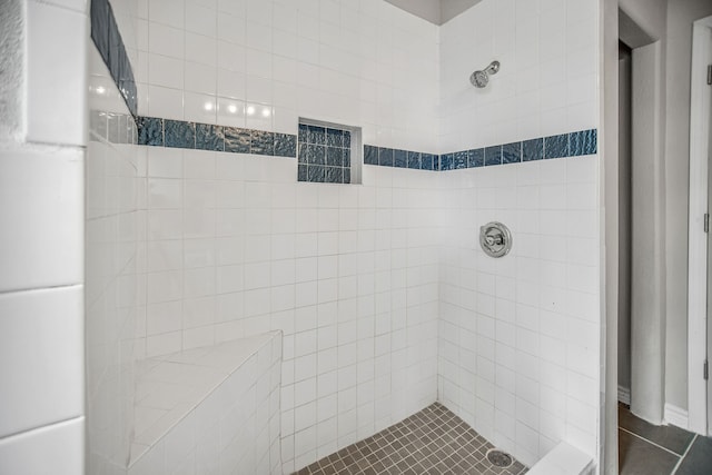 bathroom featuring a tile shower and tile patterned floors