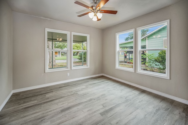 unfurnished room featuring light wood-type flooring and ceiling fan