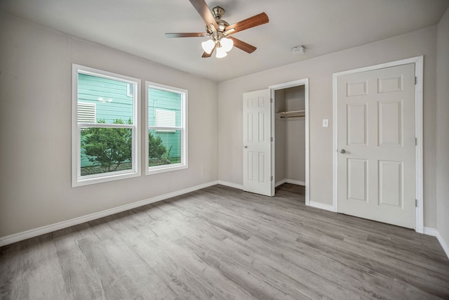 unfurnished bedroom with ceiling fan and light hardwood / wood-style flooring