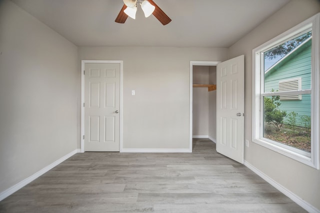 unfurnished bedroom featuring light wood-type flooring and ceiling fan