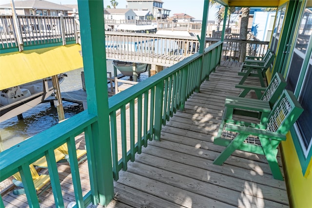 wooden terrace with a water view and a dock