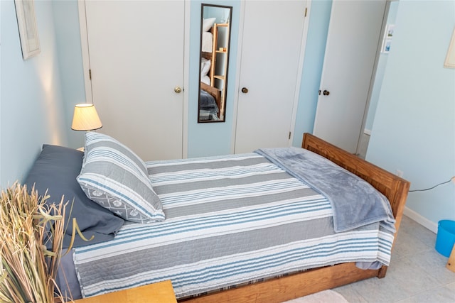 bedroom featuring a closet and light tile patterned flooring