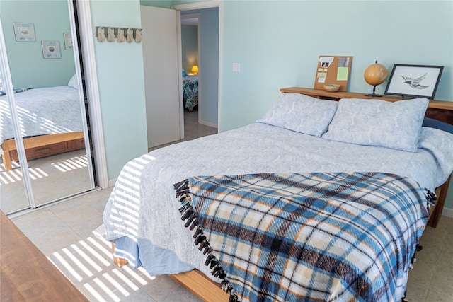 bedroom featuring a closet and light tile patterned floors