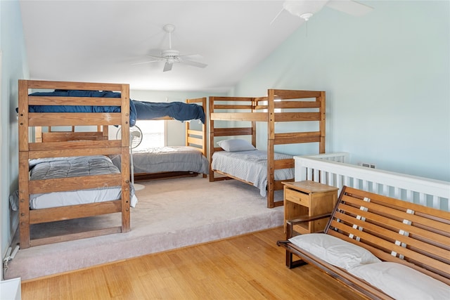 bedroom with ceiling fan, vaulted ceiling, and hardwood / wood-style flooring