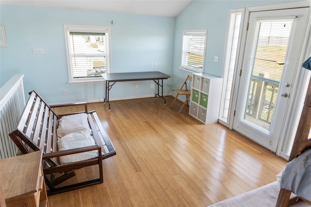 sitting room featuring lofted ceiling and light wood-type flooring