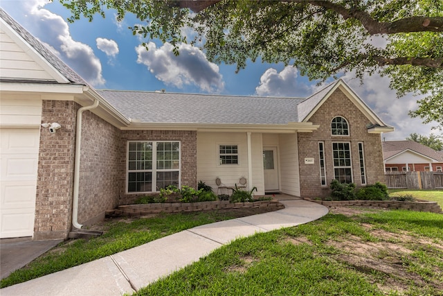 single story home with a garage and a front yard