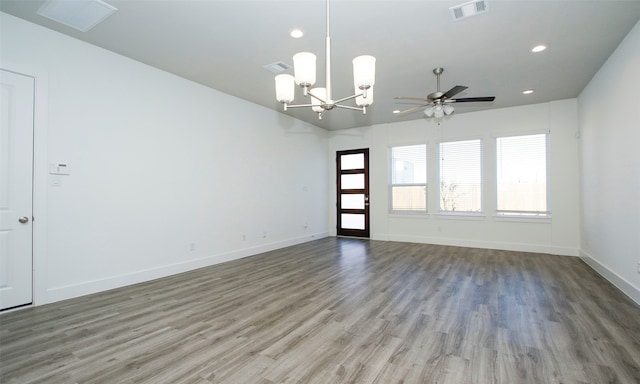 unfurnished room featuring ceiling fan with notable chandelier and wood-type flooring