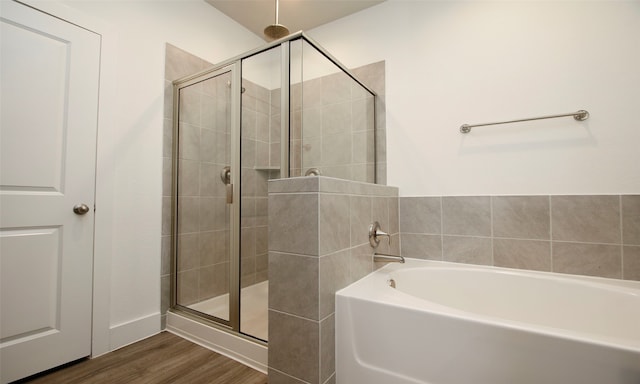 bathroom featuring separate shower and tub and hardwood / wood-style flooring