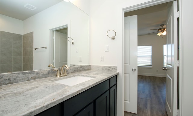 bathroom featuring hardwood / wood-style flooring, ceiling fan, and vanity