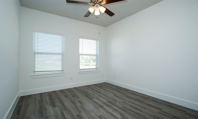 unfurnished room with ceiling fan and dark hardwood / wood-style flooring