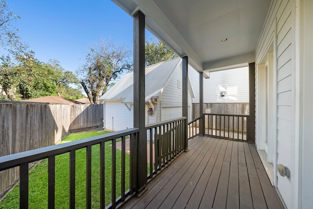 wooden deck featuring a lawn