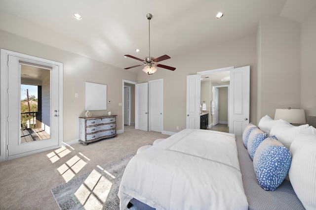 bedroom with ceiling fan, access to exterior, ensuite bathroom, light carpet, and vaulted ceiling