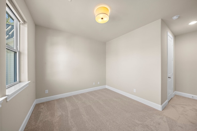 spare room with light carpet