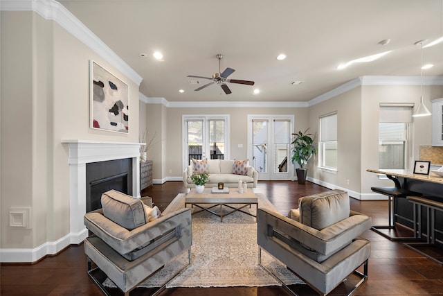 living room featuring ceiling fan, ornamental molding, and dark wood-type flooring