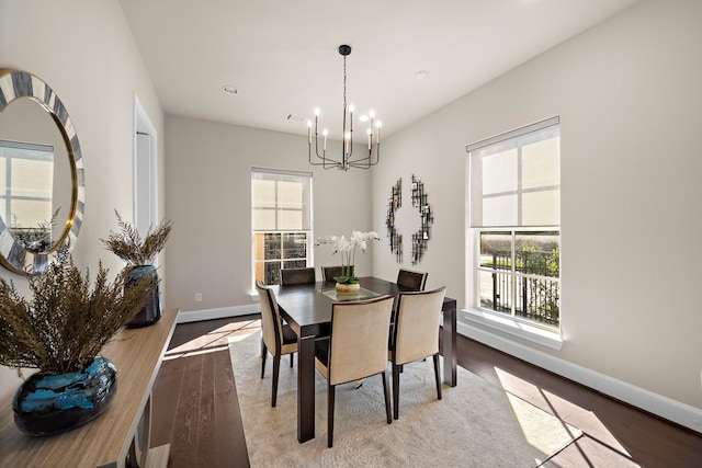 dining space with a chandelier and light hardwood / wood-style flooring