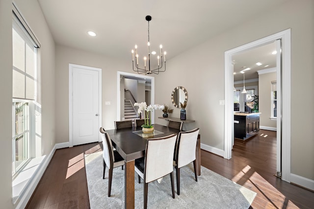 dining space featuring dark hardwood / wood-style floors and a notable chandelier