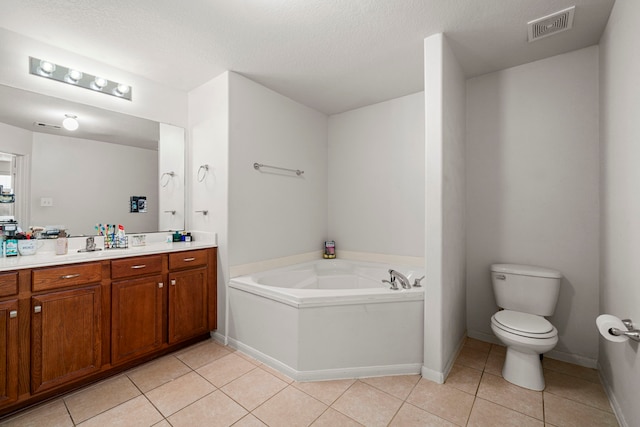 bathroom with a washtub, tile patterned flooring, a textured ceiling, toilet, and vanity