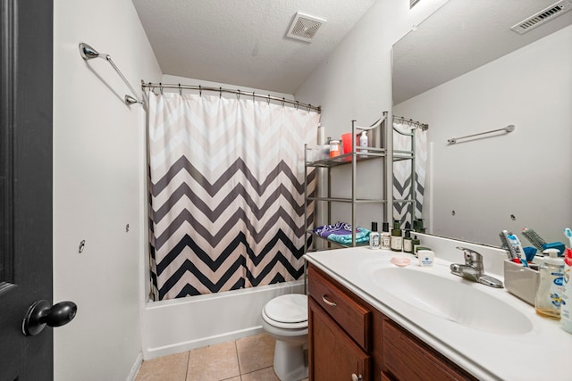 full bathroom featuring shower / bath combination with curtain, a textured ceiling, vanity, tile patterned flooring, and toilet