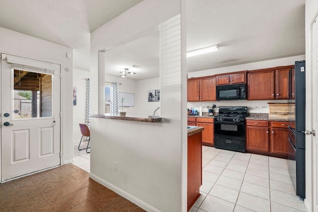 kitchen featuring light tile patterned floors and black appliances