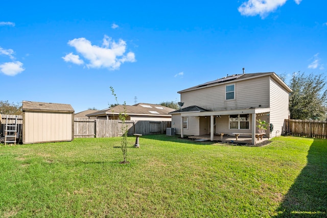 back of house with a patio, central AC unit, a storage shed, and a lawn