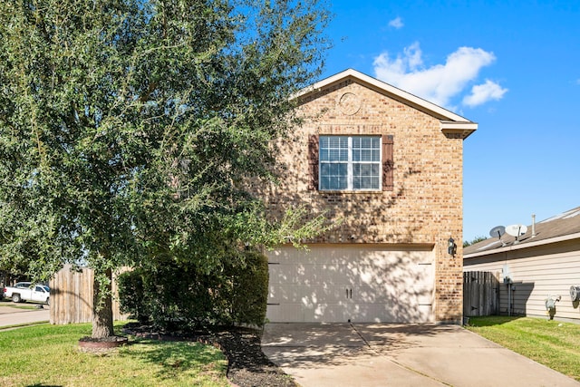 view of property with a garage and a front lawn