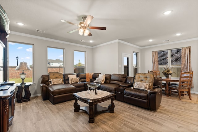 living room featuring ceiling fan, light wood-type flooring, and ornamental molding