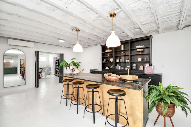 bar featuring a wall mounted air conditioner and pendant lighting