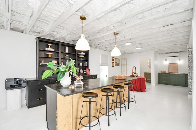 kitchen featuring a kitchen bar, a wall mounted AC, and decorative light fixtures