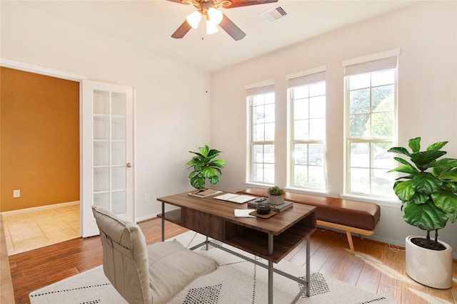 office with wood-type flooring and ceiling fan