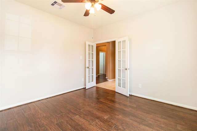 unfurnished room with french doors, ceiling fan, and dark wood-type flooring