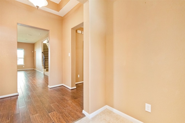 hallway with hardwood / wood-style floors