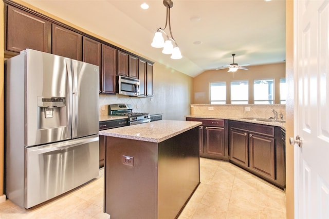 kitchen featuring appliances with stainless steel finishes, tasteful backsplash, dark brown cabinetry, a center island, and lofted ceiling