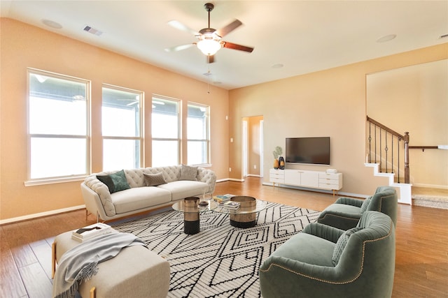 living room with hardwood / wood-style flooring and ceiling fan