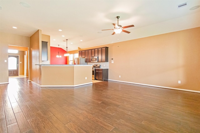 unfurnished living room with ceiling fan and dark wood-type flooring