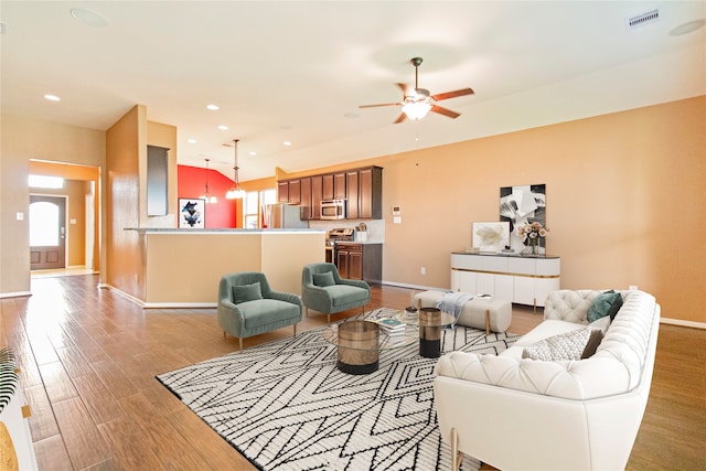 living room with ceiling fan and wood-type flooring