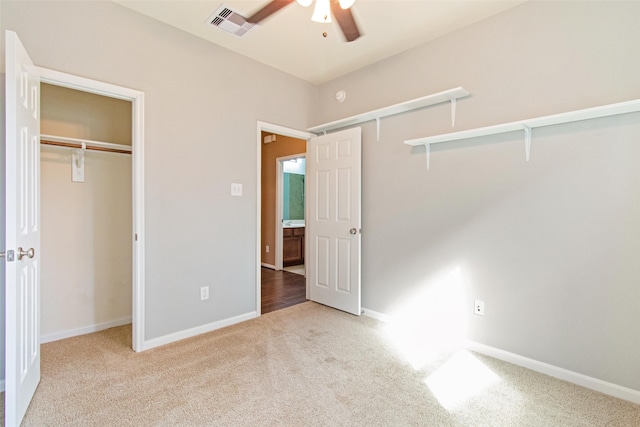 unfurnished bedroom featuring ceiling fan and light carpet