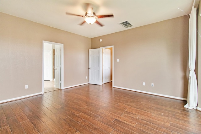 unfurnished room with ceiling fan and hardwood / wood-style floors